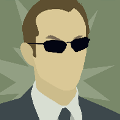 icomania:A man with small black sunglasses in a suit.